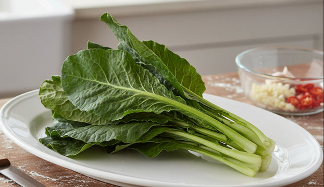 Bunch of green leafy vegetables on a white background